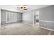 Bedroom with neutral carpet, ceiling fan, and adjoining bathroom at 300 Smith Ave, Bowdon, GA 30108