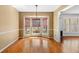 Dining room with hardwood floors, chair rail, and a bay window with woven shades at 300 Smith Ave, Bowdon, GA 30108