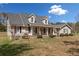 Charming home featuring a covered front porch, landscaped yard, and black shutters at 300 Smith Ave, Bowdon, GA 30108