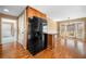 Bright kitchen with hardwood floors, black refrigerator, and breakfast bar at 300 Smith Ave, Bowdon, GA 30108