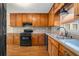 Well-equipped kitchen with wooden cabinets, modern appliances, and hardwood floors at 300 Smith Ave, Bowdon, GA 30108