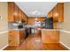 Functional kitchen with wooden cabinets, hardwood floors, and modern appliances at 300 Smith Ave, Bowdon, GA 30108