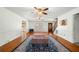 Large living room featuring hardwood floors, ceiling fans, and abundant natural light at 300 Smith Ave, Bowdon, GA 30108
