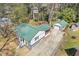 Aerial view of the house with a green roof, detached garage, and long driveway at 6414 Bimini Dr, Forest Park, GA 30297