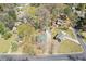 An aerial view of a well-situated home with mature trees, garage, and driveway, on a corner lot at 6414 Bimini Dr, Forest Park, GA 30297