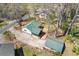 Aerial view of house and detached garage with long driveway and mature trees at 6414 Bimini Dr, Forest Park, GA 30297