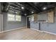 Finished basement with open ceiling, gray walls, wood-look floors, and a window at 6414 Bimini Dr, Forest Park, GA 30297