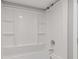 Bathroom featuring shower with built-in shelving and updated shower head at 6414 Bimini Dr, Forest Park, GA 30297
