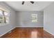 A bright bedroom featuring hardwood floors and two windows providing an outdoor view at 6414 Bimini Dr, Forest Park, GA 30297