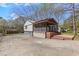Home exterior with a screened porch, driveway, and manicured landscaping at 6414 Bimini Dr, Forest Park, GA 30297