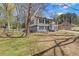 Side view of two-story home with manicured lawn and mature trees, providing shade and curb appeal at 6414 Bimini Dr, Forest Park, GA 30297