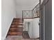 Inviting foyer with wood stairs, iron railing, and tile flooring offering a warm and stylish entrance at 6414 Bimini Dr, Forest Park, GA 30297