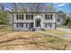 Charming two-story home featuring fresh paint, black shutters, and a welcoming front entrance at 6414 Bimini Dr, Forest Park, GA 30297