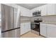 Contemporary kitchen featuring stainless steel appliances, white cabinets, and ample storage for modern living at 6414 Bimini Dr, Forest Park, GA 30297