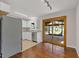 Modern kitchen with white cabinets, stainless steel appliances, and a sliding door leading to the deck at 6414 Bimini Dr, Forest Park, GA 30297