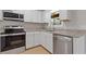 Well-equipped kitchen with stainless steel appliances, white cabinets, and granite countertops providing a functional space at 6414 Bimini Dr, Forest Park, GA 30297
