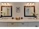 Double vanity bathroom with modern fixtures, granite counters and decorative mirrors at 717 Farmstead Rd, Suwanee, GA 30024