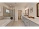 Bright bathroom with double sinks, quartz countertop, walk-in shower and soaking tub at 717 Farmstead Rd, Suwanee, GA 30024