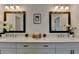 Bright bathroom featuring double sinks, framed mirrors, and a quartz counter at 717 Farmstead Rd, Suwanee, GA 30024