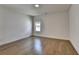 This bedroom features hardwood floors and a window at 717 Farmstead Rd, Suwanee, GA 30024