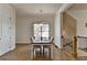 Bright dining room featuring modern light fixture, white trim, hardwood floors and staircase access at 717 Farmstead Rd, Suwanee, GA 30024