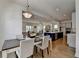 Open concept dining room with hardwood floors, view of living room, kitchen island and stainless appliances at 717 Farmstead Rd, Suwanee, GA 30024