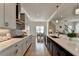 Modern kitchen with gray cabinets, gray subway tile backsplash, stainless steel range hood and hardwood floors at 717 Farmstead Rd, Suwanee, GA 30024