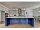 Gourmet kitchen with island, gray and dark blue cabinets, quartz countertops, hardwood floors and stainless appliances at 717 Farmstead Rd, Suwanee, GA 30024