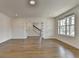 Bright and open living area featuring hardwood floors, recessed lighting and sliding doors to a stairway at 717 Farmstead Rd, Suwanee, GA 30024