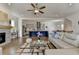 Modern living room featuring a fireplace, hardwood floors, and an open kitchen at 717 Farmstead Rd, Suwanee, GA 30024