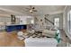 Open-concept living room with a kitchen island and hardwood floors at 717 Farmstead Rd, Suwanee, GA 30024