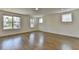 Bright, expansive living room with hardwood floors, neutral walls and multiple windows for plenty of natural light at 717 Farmstead Rd, Suwanee, GA 30024
