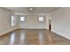 Spacious living room with wood flooring, recessed lighting and two double windows that offer an abundance of light at 717 Farmstead Rd, Suwanee, GA 30024