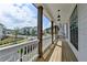 Charming covered porch with wood columns and community view at 717 Farmstead Rd, Suwanee, GA 30024