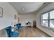 Well-lit sitting room with hardwood floors, blue chairs, and a window view at 717 Farmstead Rd, Suwanee, GA 30024