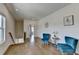 Upstairs sitting room featuring hardwood floors, comfortable blue chairs, and natural light at 717 Farmstead Rd, Suwanee, GA 30024