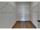 A walk-in closet features hardwood floors and wire shelving at 717 Farmstead Rd, Suwanee, GA 30024