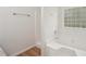 Bright bathroom with a soaking tub, a tiled shower, and a window at 164 Edison Dr, Stockbridge, GA 30281