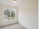 A carpeted bedroom with a large window providing ample natural light and neighborhood views at 164 Edison Dr, Stockbridge, GA 30281