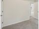A spacious carpeted bedroom featuring two doors, and neutral wall paint at 164 Edison Dr, Stockbridge, GA 30281