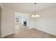 Open dining room with wood-look floors, chandelier lighting, and easy access to the living room for seamless entertaining at 164 Edison Dr, Stockbridge, GA 30281