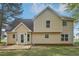 Two-story home with beige siding, a concrete patio, and multiple windows offering lots of natural light at 164 Edison Dr, Stockbridge, GA 30281