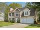 Charming two-story home featuring stone accents, a two-car garage, and a well-maintained front lawn at 164 Edison Dr, Stockbridge, GA 30281