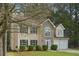 Inviting two-story home enhanced by a stone facade, lush lawn, and the shade of mature trees at 164 Edison Dr, Stockbridge, GA 30281