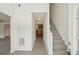 Inviting foyer with wood-look flooring, staircase, and views into the kitchen, creating a warm and welcoming entrance at 164 Edison Dr, Stockbridge, GA 30281