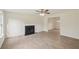 Cozy living room with a fireplace, neutral paint, and wood-look flooring, perfect for relaxing or entertaining guests at 164 Edison Dr, Stockbridge, GA 30281