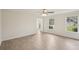 Bright living room featuring wood-look flooring, two windows, and neutral walls, offering a versatile and comfortable space at 164 Edison Dr, Stockbridge, GA 30281