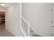 Hallway with stairs, wood-look floors, and a white banister leading to the second floor at 164 Edison Dr, Stockbridge, GA 30281