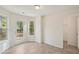 Bright sun room with wood-look flooring, large windows, and a door leading to the backyard at 164 Edison Dr, Stockbridge, GA 30281