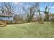 Expansive backyard with green grass, mature trees, and privacy fencing at 2243 Newnan St, Atlanta, GA 30344